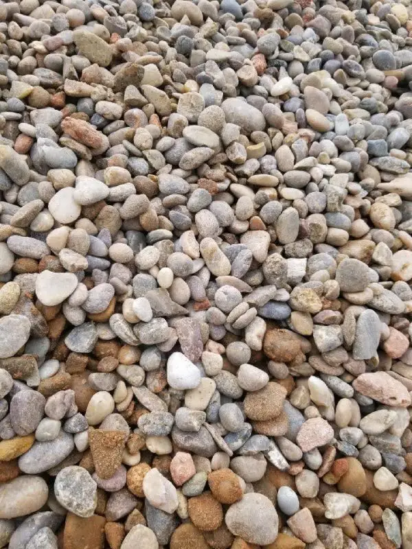 A pile of 1.5" Canadian River Rock on the ground.