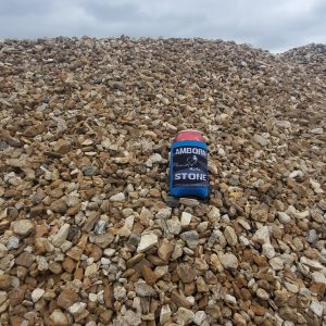 A 1" Buffalo River Rock standing on a pile of River Rocks.